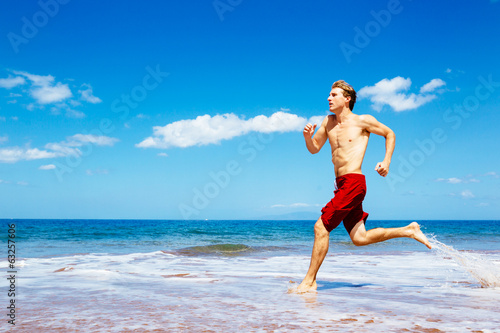 Athletic Man Running on Beach