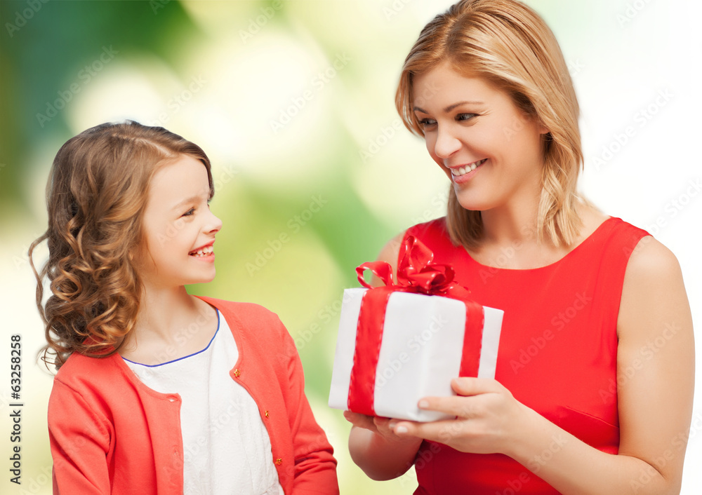 smiling mother and daughter with gift box smiling mother and daughter with gift box