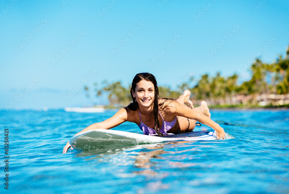 Young Woman Surfing in Hawaii, Paddling out to the Lineup