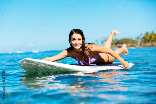 Young Woman Surfing in Hawaii, Paddling out to the Lineup
