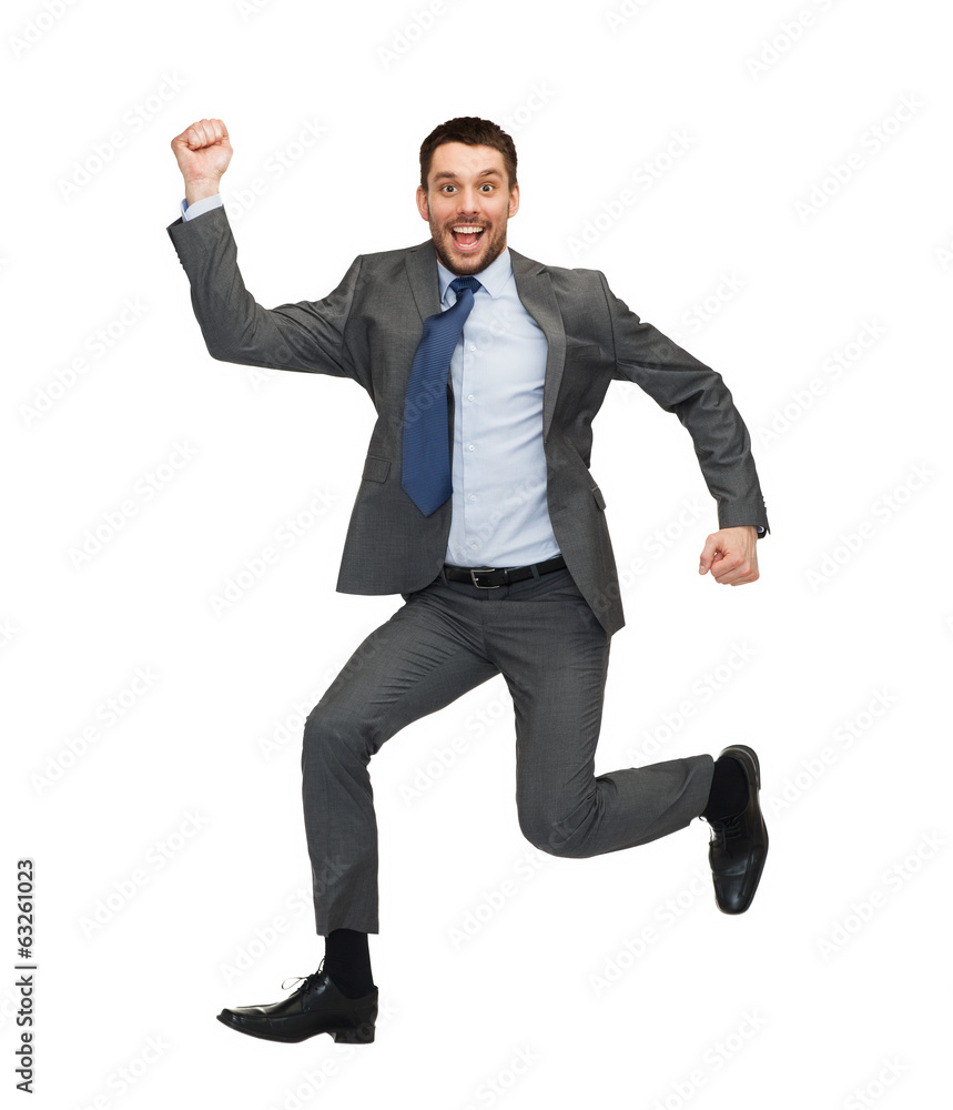 smiling businessman jumping smiling businessman jumping