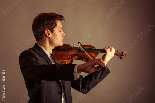 Photography Man violinist playing violin. Classical music art