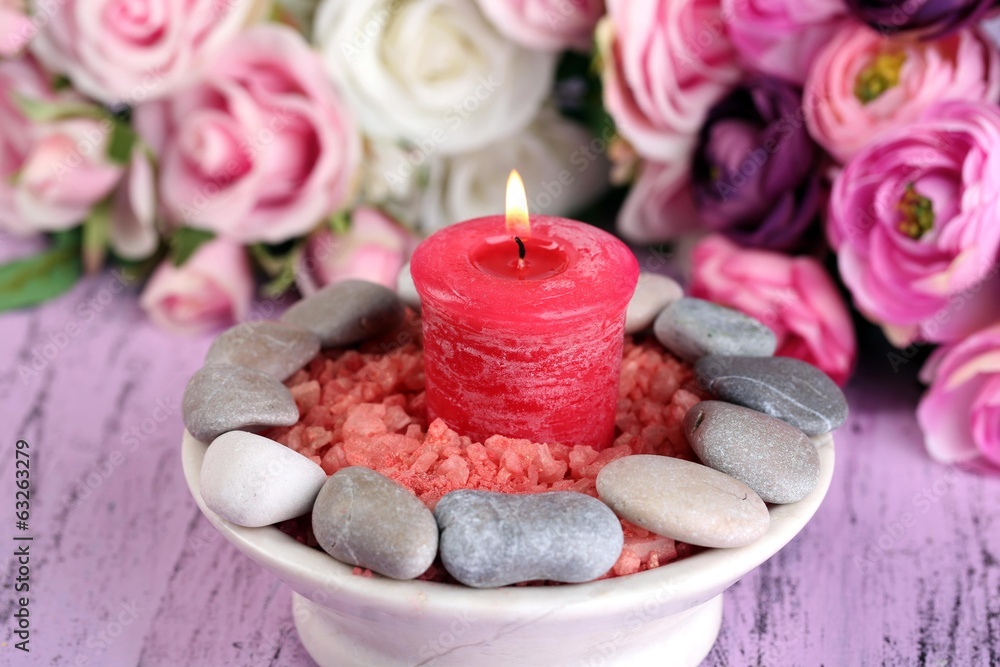 Composition with spa stones, candle  and flowers