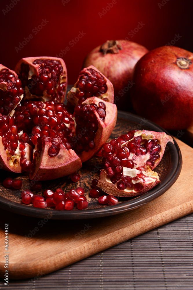 Ripe pomegranates on table close-up Ripe pomegranates on table close-up