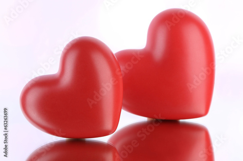 Red hearts on light background © Africa Studio