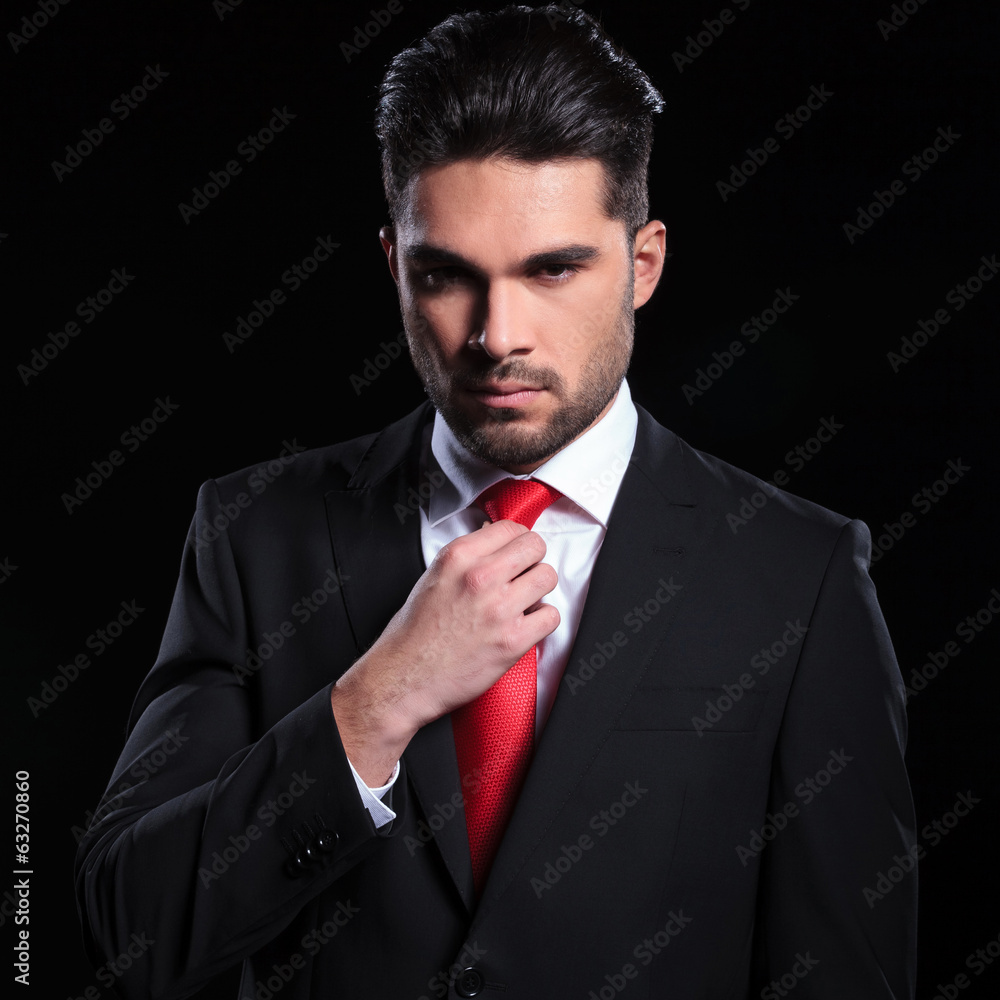 serious business man adjusts his tie serious business man adjusts his tie