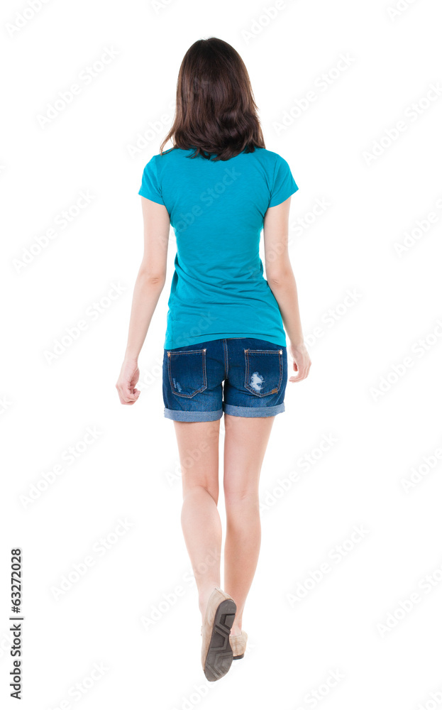 back view of walking woman in shorts. back view of walking woman in shorts.