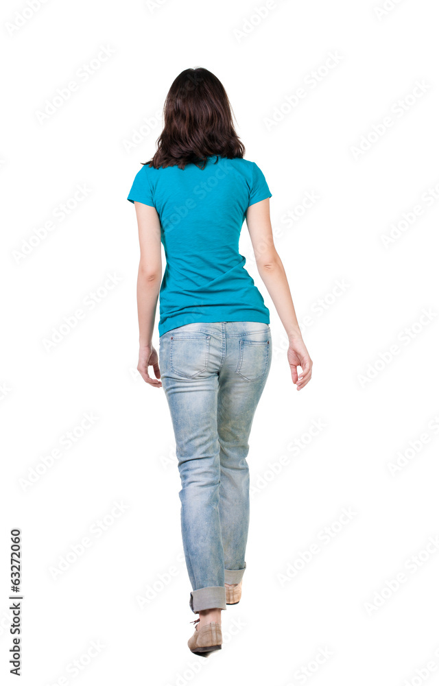 back view of walking woman in jeans . back view of walking woman in jeans .