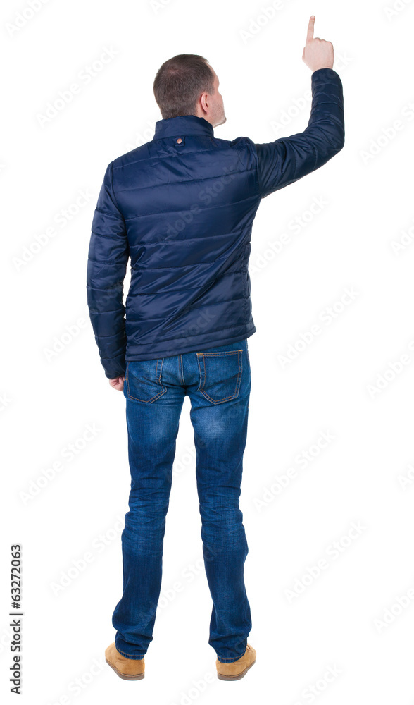 Back view of pointing young men in jacket and jeans. Back view of pointing young men in jacket and jeans.