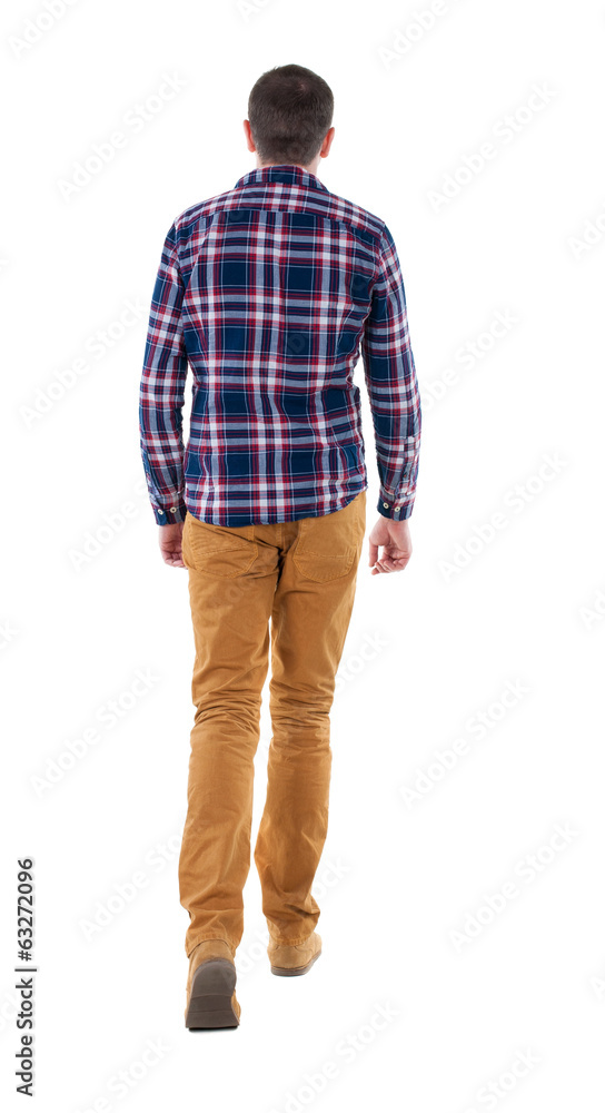 Back view of going handsome man in checkered shirt. Back view of going handsome man in checkered shirt.