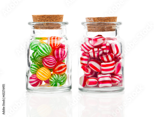two filled glass candy jars isolated over white background