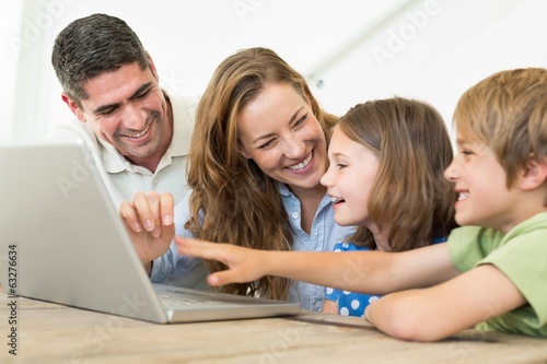Cheerful family using laptop
