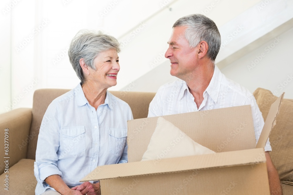 Cheerful senior couple moving into new home Cheerful senior couple moving into new home