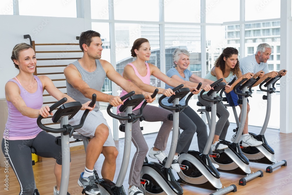 Happy people working out at spinning class Happy people working out at spinning class