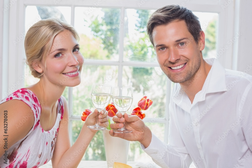 Happy young couple toasting wine glasses Happy young couple toasting wine glasses