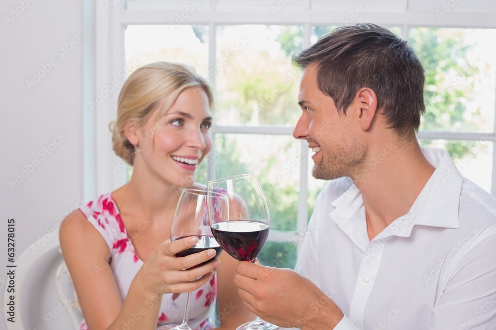 Loving couple with wine glasses looking at each other Loving couple with wine glasses looking at each other
