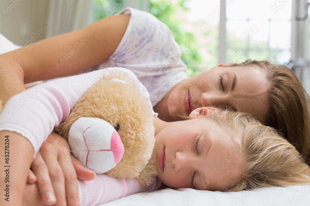 Girl and mother sleeping peacefully with stuffed toy Girl and mother sleeping peacefully with stuffed toy