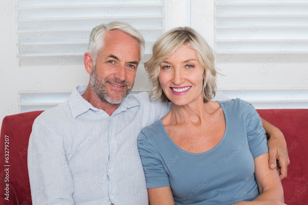 Portrait of smiling mature couple on couch Portrait of smiling mature couple on couch