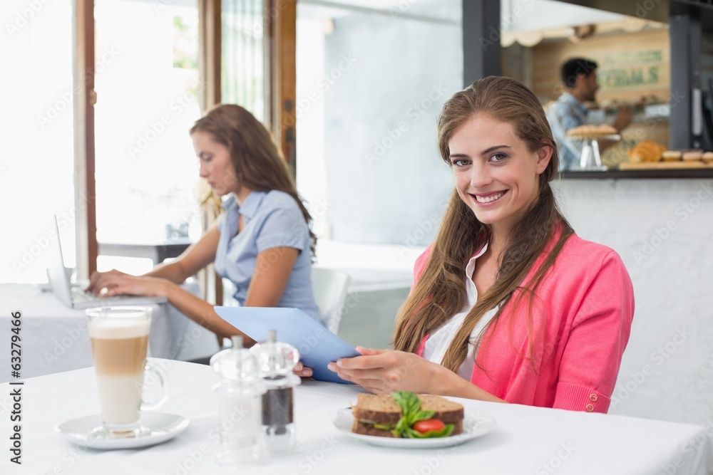 Woman using digital tablet in coffee shop Woman using digital tablet in coffee shop