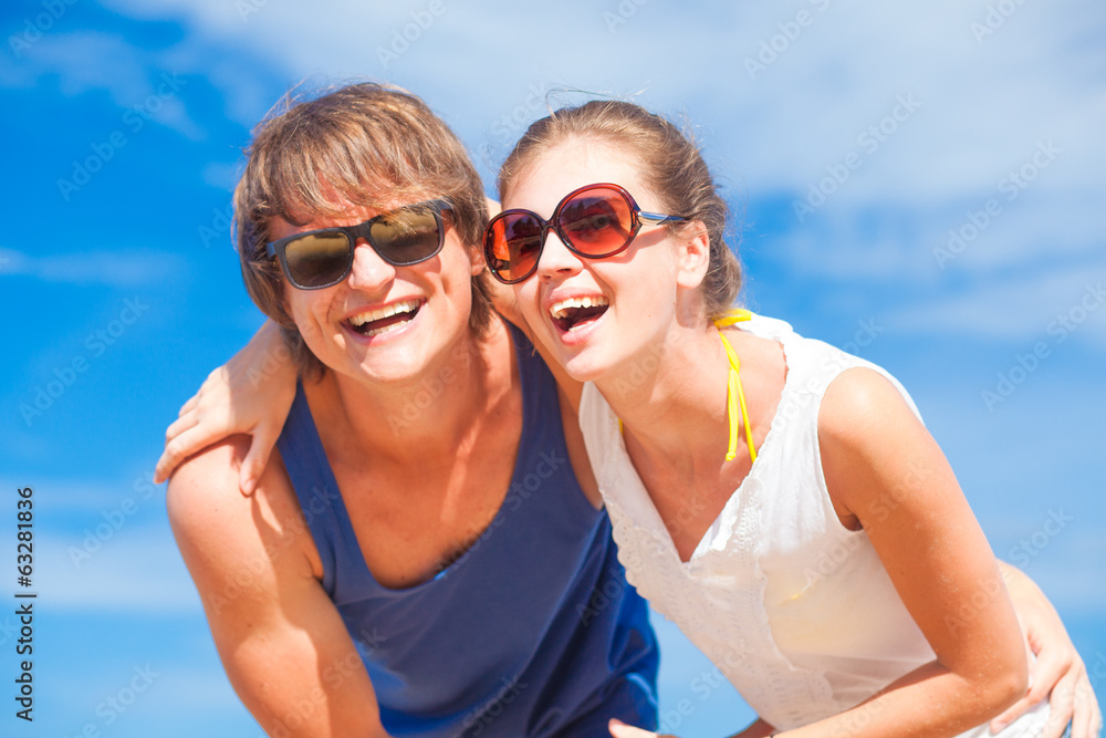Portrait of happy young couple in sunglasses having fun on Portrait of happy young couple in sunglasses having fun on