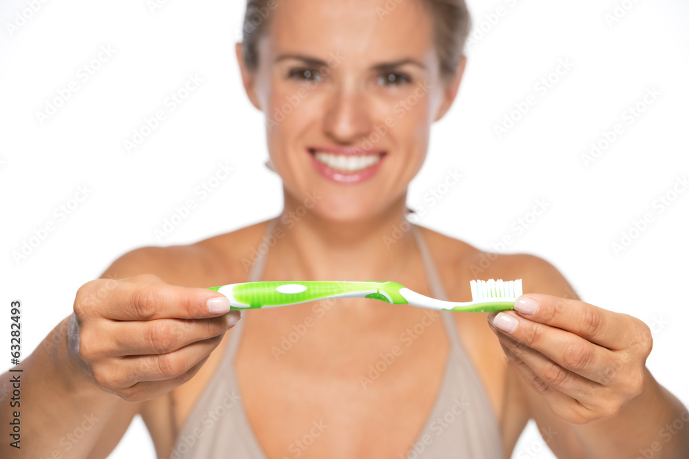 Closeup on happy young woman showing toothbrush Closeup on happy young woman showing toothbrush