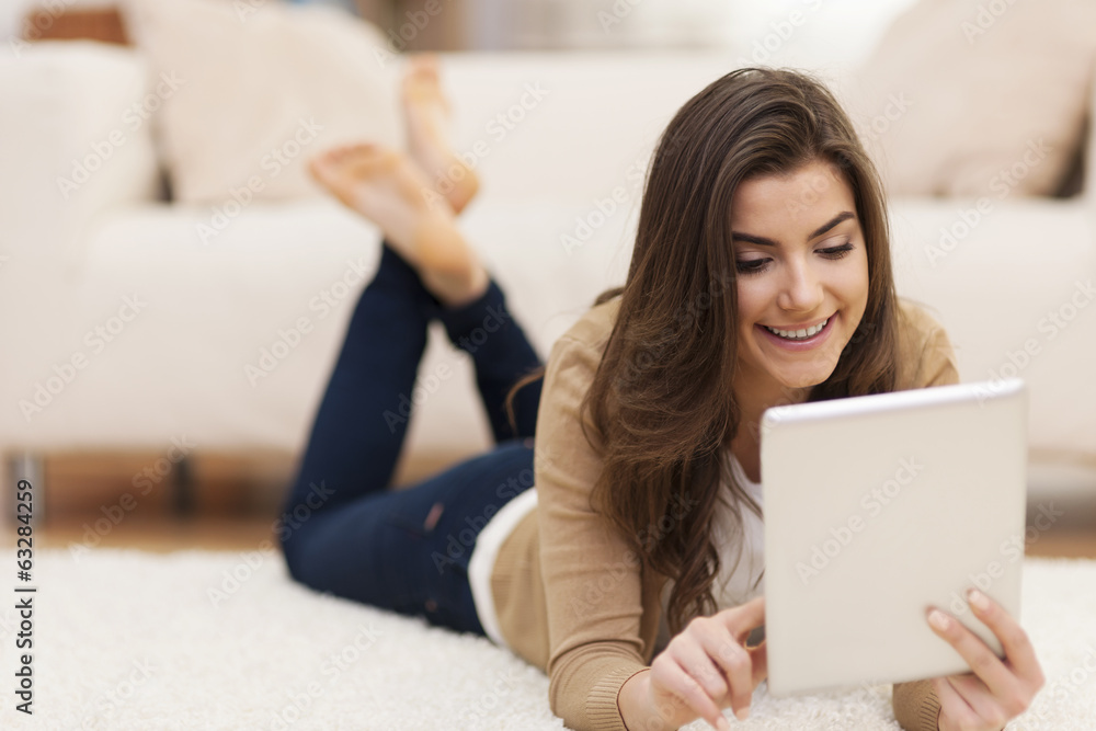Attractive woman on carpet using digital tablet Attractive woman on carpet using digital tablet