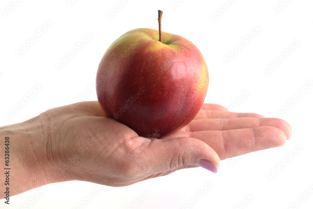 Apple in feminine hand isolated on white background Apple in feminine hand isolated on white background