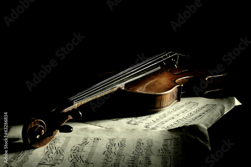 Old scratched violin in shadow