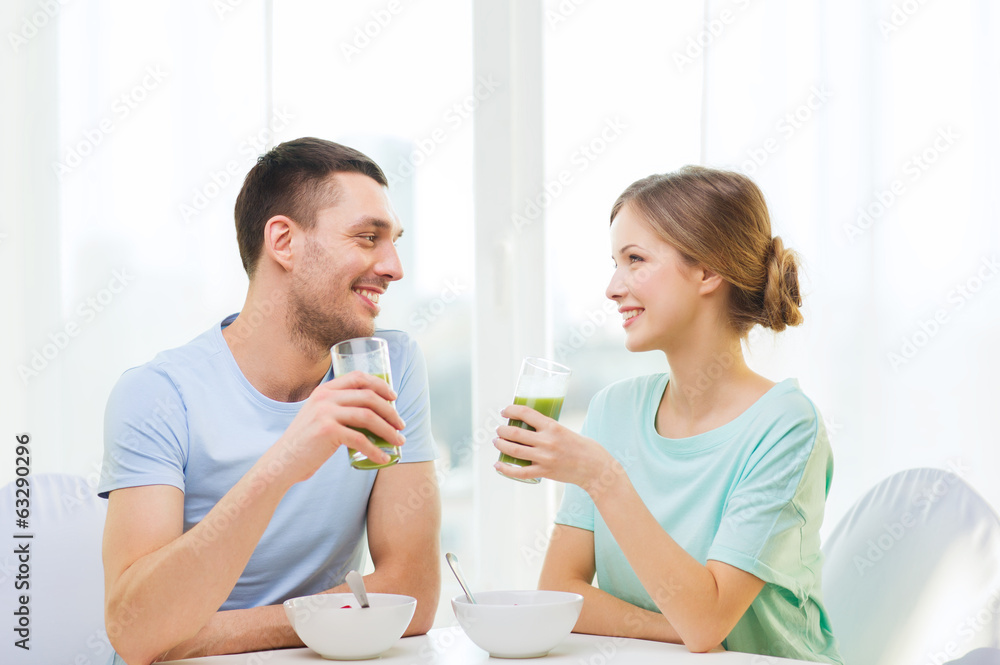 smiling couple having breakfast at home