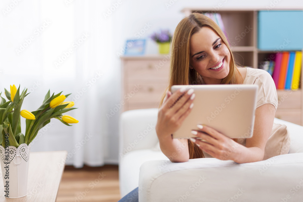 Happy woman with digital tablet at home Happy woman with digital tablet at home