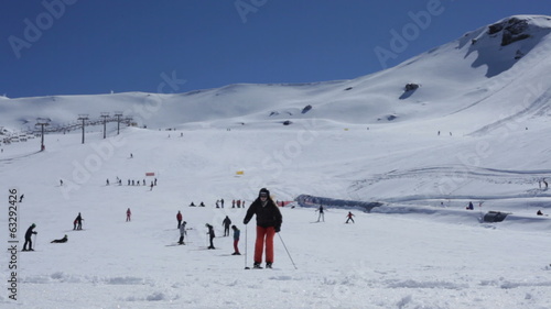 Young woman skiing during sunny day in Sierra Nevada, Spain.