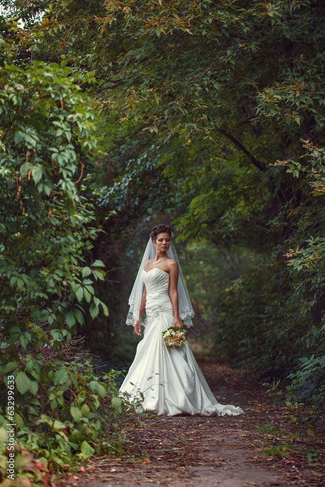 Fototapeta premium bride with a bouquet in the hand