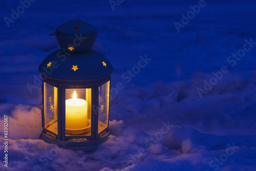 Lantern on snow photo