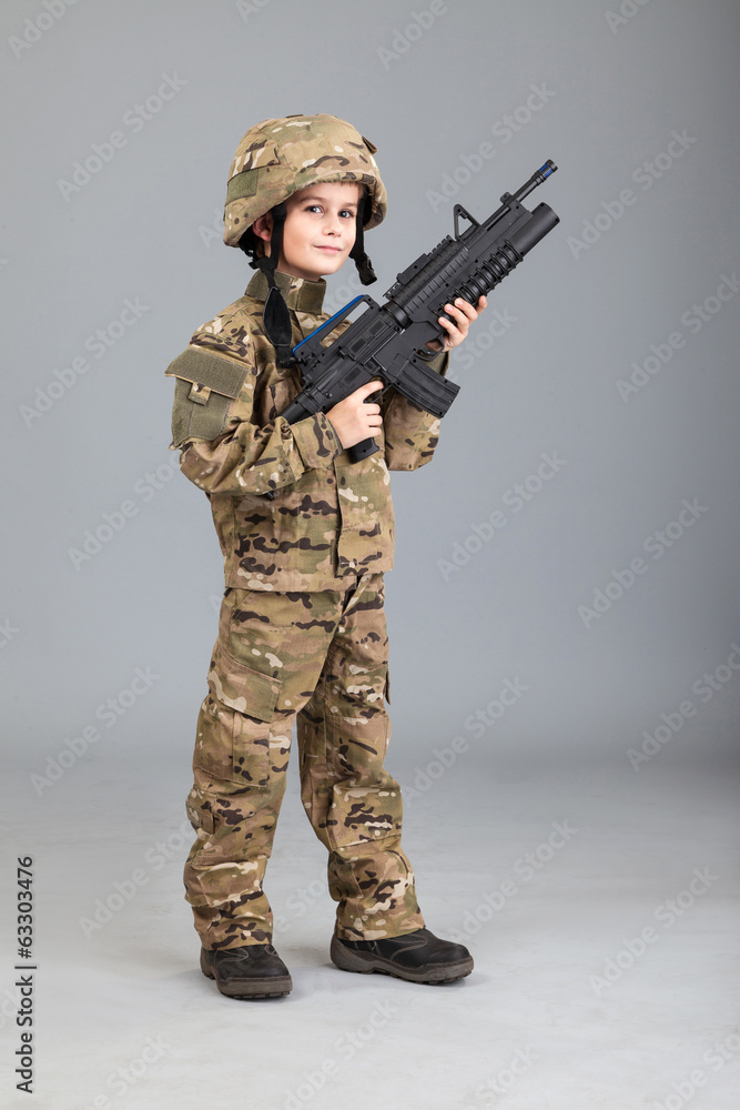 Young boy dressed like a soldier with rifle Young boy dressed like a soldier with rifle