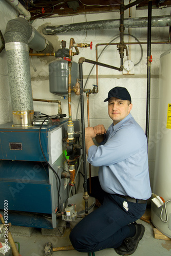 Service technician repairs furnace