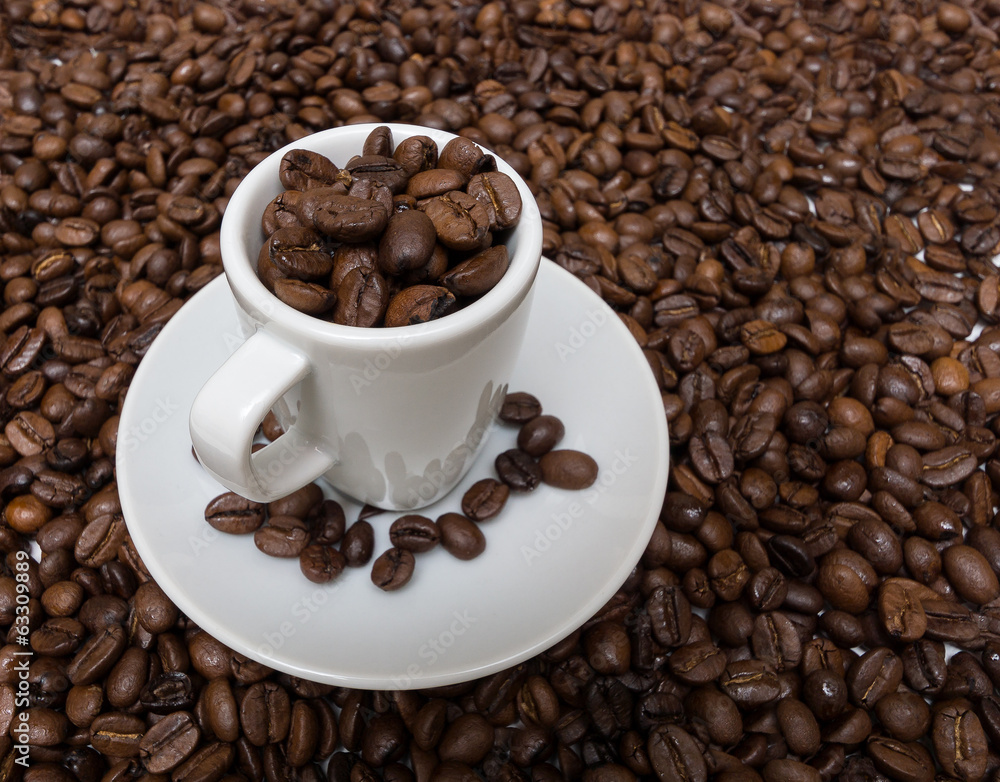 Cup with coffee beans on the background of the coffee beans Cup with coffee beans on the background of the coffee beans