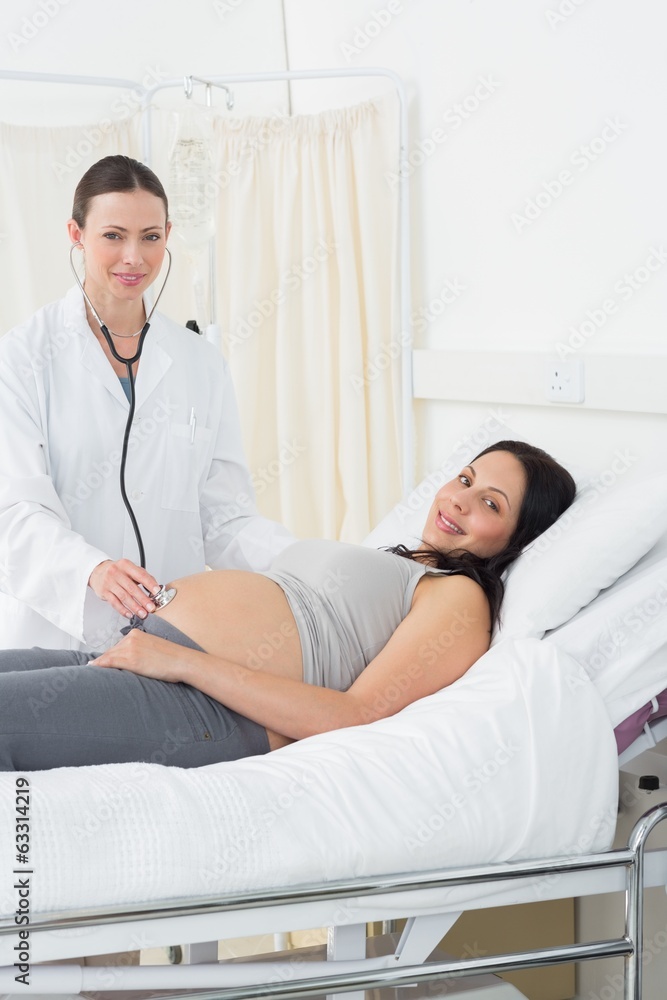Confident doctor examining pregnant woman Confident doctor examining pregnant woman