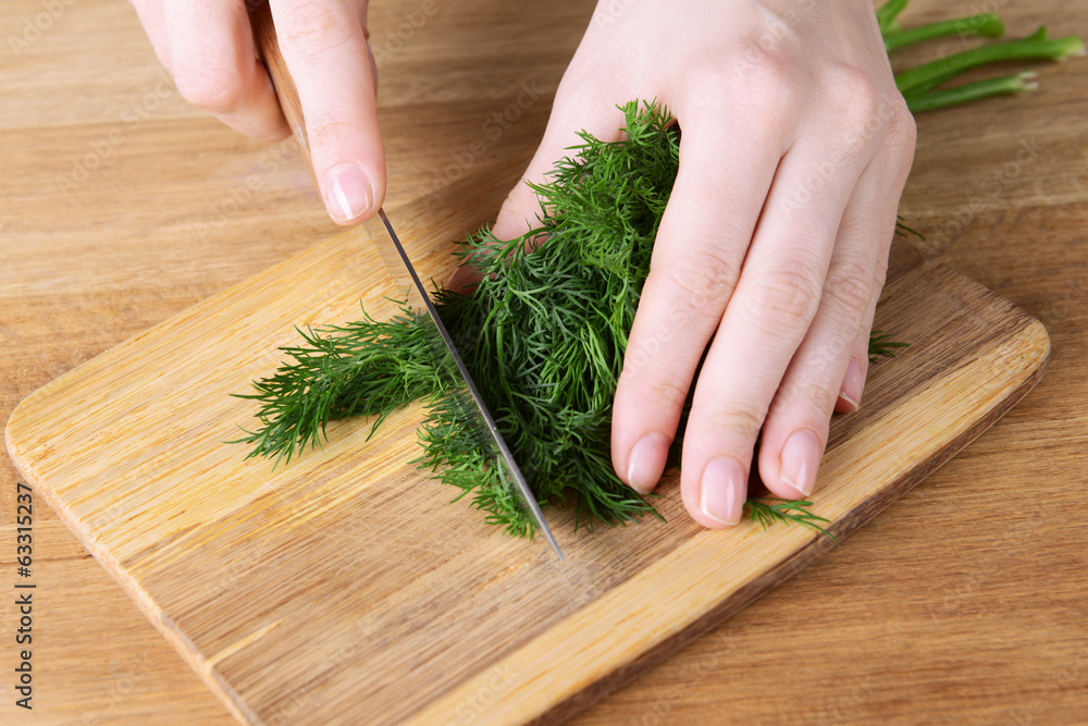 Chopped dill on wooden board close-up Chopped dill on wooden board close-up