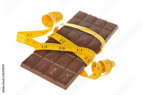 Chocolate bar wrapped with measure tape isolated on white photo