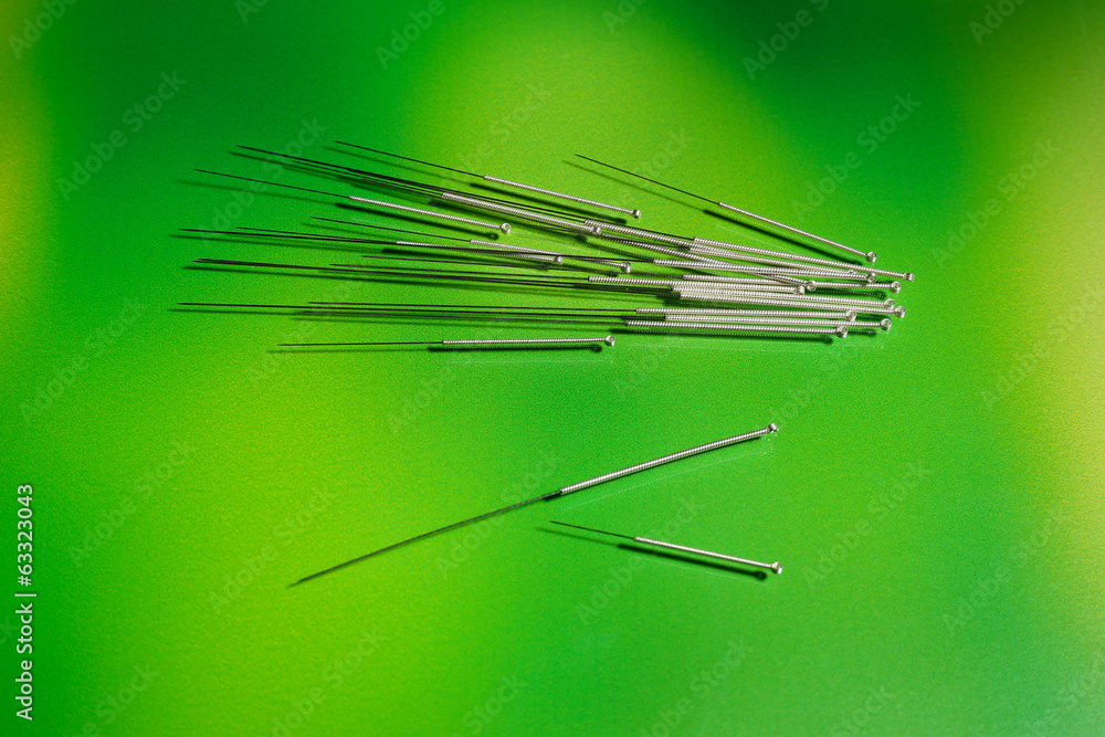 Needles for acupuncture on green background Needles for acupuncture on green background