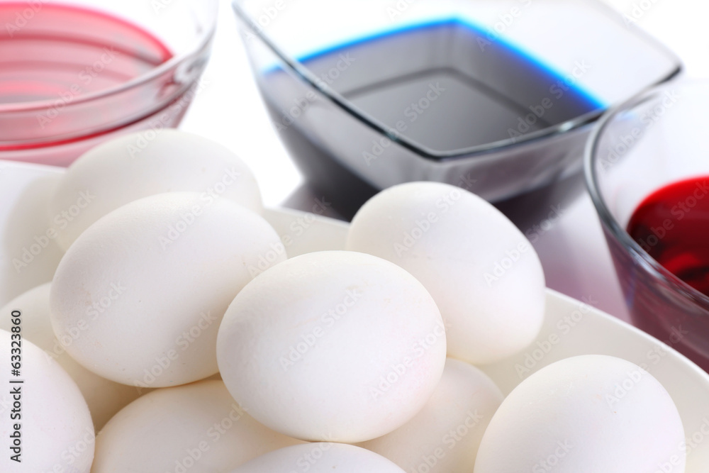 Eggs with liquid colour in glass bowls close up Eggs with liquid colour in glass bowls close up