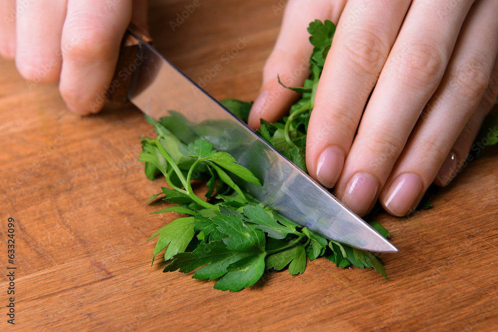 Chopped parsley on wooden board close-up Chopped parsley on wooden board close-up