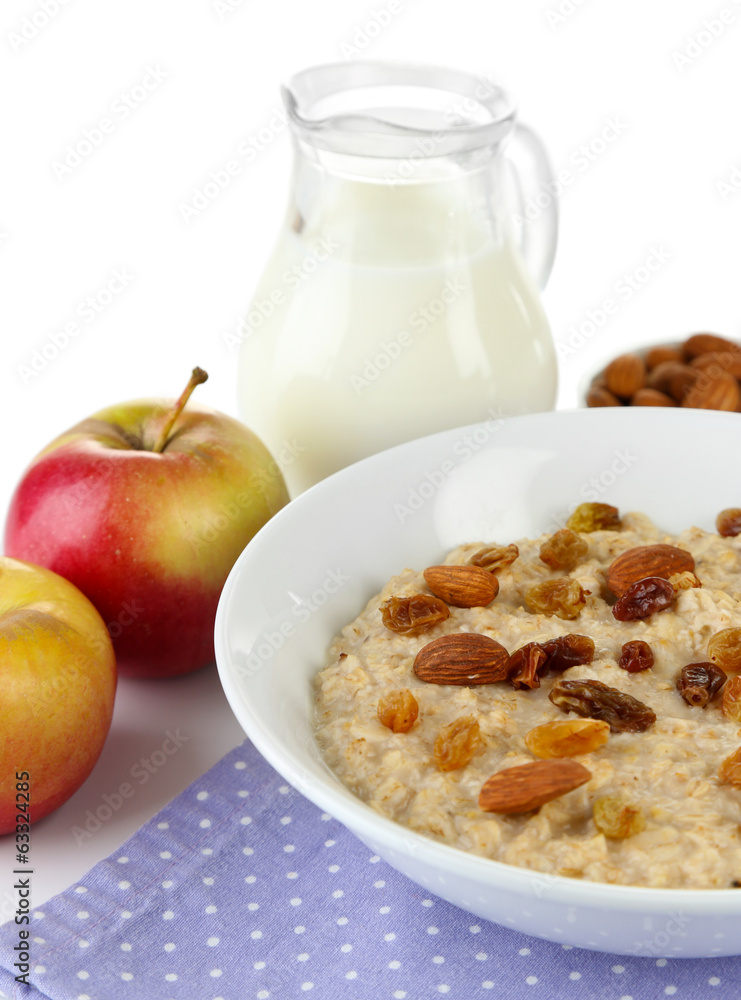 Tasty oatmeal with raisins and apples isolated on white Tasty oatmeal with raisins and apples isolated on white