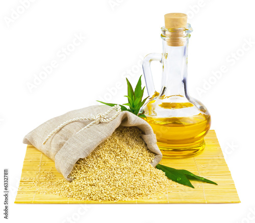 Sack of sesame seeds and glass bottle of oil