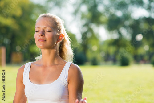 attractive woman of exercises on the grass