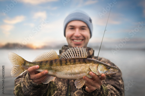 Happy angler with zander fishing trophy