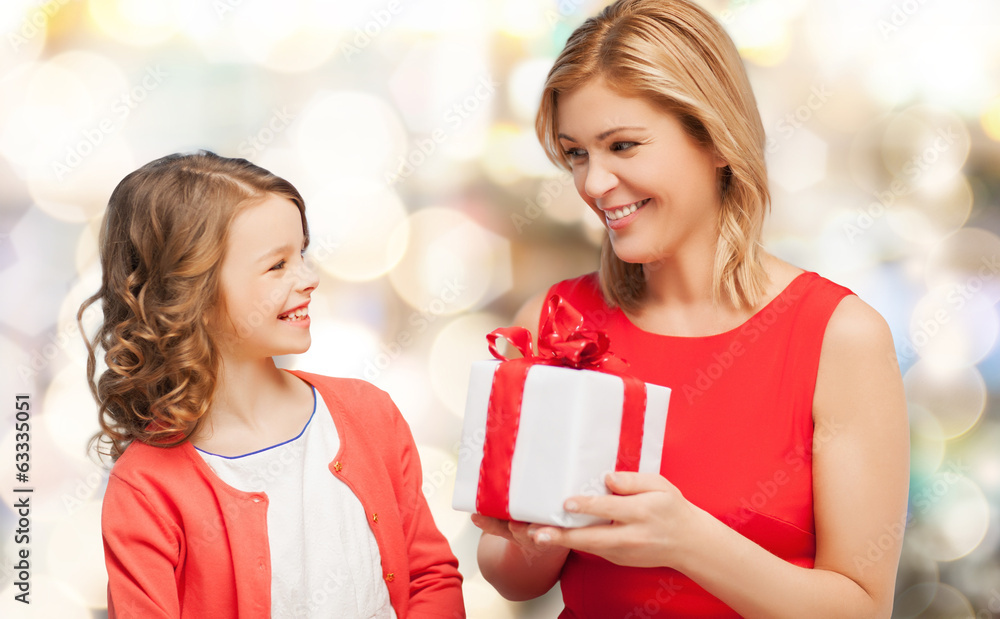 smiling mother and daughter with gift box smiling mother and daughter with gift box