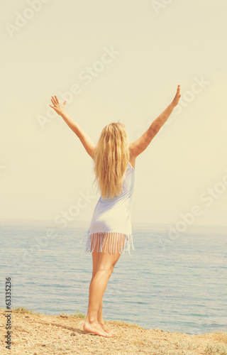 girl doing exercises on the beach