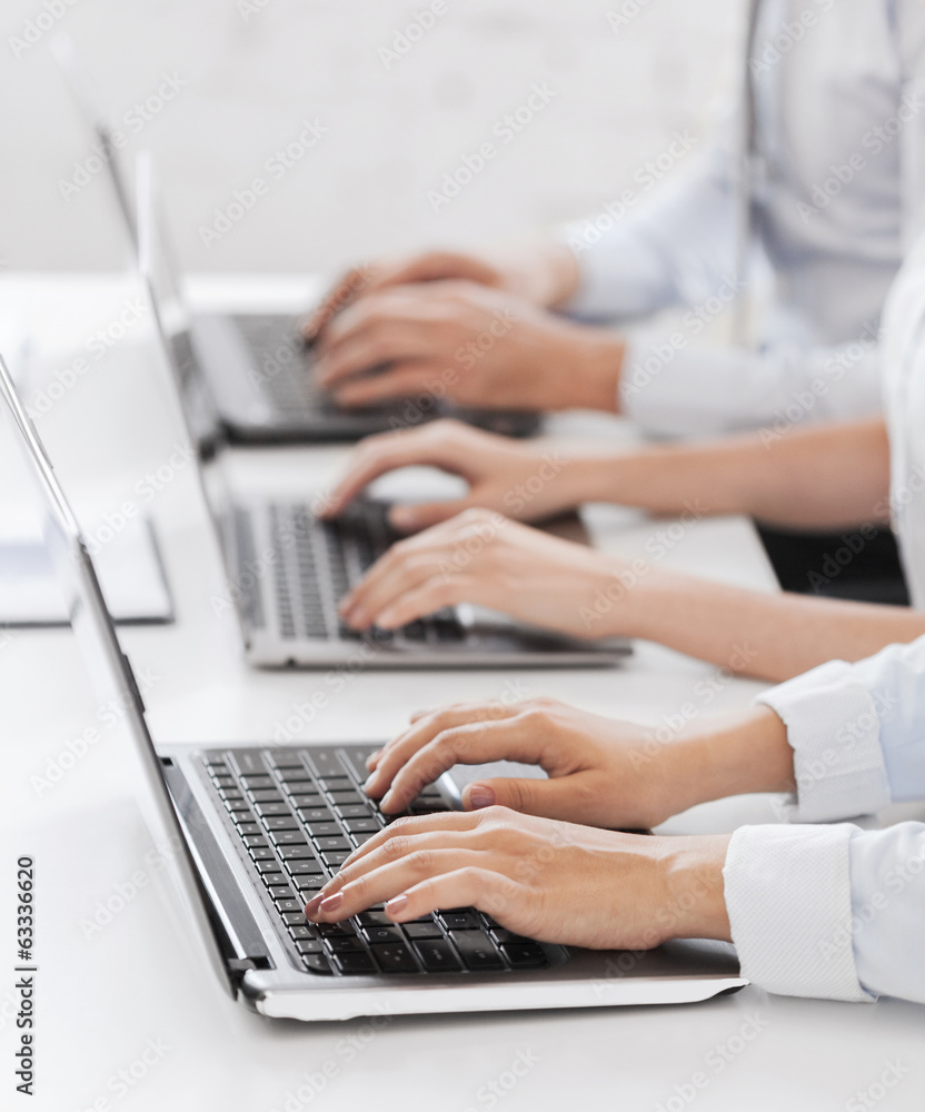 Fototapeta premium group of people working with laptops in office