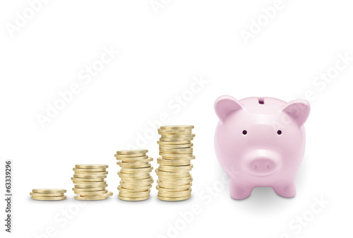 Pink piggy bank and coins. Isolated on white